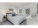 Comfortable bedroom features a plush bed, soft lighting, a bedside table, and a scenic view from the window at 501 Sagebrush St., Myrtle Beach, SC 29588