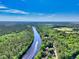 Breathtaking aerial view of a river surrounded by lush forests, with a boat cruising along the waterway at 515 River Rd., Conway, SC 29526