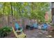 Secluded backyard sitting area with vibrant blue chairs surrounded by lush greenery and a unique bamboo fence at 515 River Rd., Conway, SC 29526
