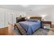 Bedroom featuring a queen bed, hardwood floors, and a neutral color palette with ample lighting at 515 River Rd., Conway, SC 29526