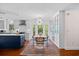 Charming dining area with modern chandelier, bright bay window, glass display cabinets and an open design to the kitchen at 515 River Rd., Conway, SC 29526