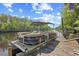 Pontoon boat docked on a private pier, perfect for waterfront living and leisurely cruises at 515 River Rd., Conway, SC 29526