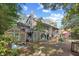 Rear exterior showcasing a multi-level deck, screened porch, greenhouse, and lush backyard at 515 River Rd., Conway, SC 29526