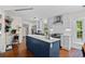 Modern kitchen with stainless steel appliances, white subway tile backsplash, and large island with countertop seating at 515 River Rd., Conway, SC 29526