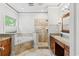 Bathroom featuring a soaking tub, walk-in shower, granite countertops, and wooden cabinets at 528 Chamberlin Rd., Myrtle Beach, SC 29588