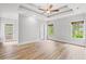 Spacious primary bedroom with tray ceiling, hardwood floors and three large windows at 528 Chamberlin Rd., Myrtle Beach, SC 29588