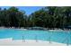 Outdoor community pool with lounge chairs and umbrellas at 528 Chamberlin Rd., Myrtle Beach, SC 29588