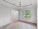 Elegant dining room features wood floors, a large window, chair rail, and modern chandelier at 528 Chamberlin Rd., Myrtle Beach, SC 29588