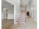 Bright foyer features hardwood floors, a staircase with wooden banister, and fireplace view at 528 Chamberlin Rd., Myrtle Beach, SC 29588