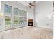 Bright living room features soaring ceilings, a fireplace, wood floors, and many windows at 528 Chamberlin Rd., Myrtle Beach, SC 29588