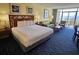 Comfortable bedroom with a plush bed, sofa, and access to a private balcony with ocean views at 5300 N Ocean Blvd. # 306, Myrtle Beach, SC 29577