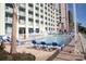 Resort with a pool and lounge chairs, providing a relaxing space by the pool at 5300 N Ocean Blvd. # 306, Myrtle Beach, SC 29577