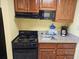 A well-equipped kitchen featuring wooden cabinets and black appliances, offering functionality and style at 5300 N Ocean Blvd. # 306, Myrtle Beach, SC 29577