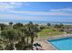 Beautiful view of beach and ocean, with palm trees and a pool in the foreground at 5300 N Ocean Blvd. # 306, Myrtle Beach, SC 29577