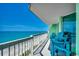 Open-air balcony with Adirondack chairs, offering stunning views of the shoreline and ocean at 5310 N Ocean Blvd. # 10B, North Myrtle Beach, SC 29582