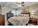 Comfortable bedroom featuring a ceiling fan, a wooden dresser, and an inviting, patterned bedspread at 5310 N Ocean Blvd. # 10B, North Myrtle Beach, SC 29582
