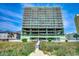 Inviting, upscale condominium building in mint green with a private beach access walkway to the beach at 5310 N Ocean Blvd. # 10B, North Myrtle Beach, SC 29582