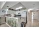 Kitchen with white cabinets, modern appliances, and a breakfast bar at 5310 N Ocean Blvd. # 10B, North Myrtle Beach, SC 29582