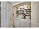Convenient laundry room with a washing machine, dryer, and shelving for storage at 5310 N Ocean Blvd. # 10B, North Myrtle Beach, SC 29582