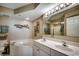 Bright main bathroom with double sinks, soaking tub, and coastal-themed decor at 5310 N Ocean Blvd. # 10B, North Myrtle Beach, SC 29582