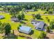 Aerial view of the property featuring a blue building, and a house surrounded by green landscape at 5589 Highway 668, Conway, SC 29526