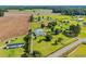 Expansive aerial view of property showcasing home, farmland, outbuildings and lush greenery at 5589 Highway 668, Conway, SC 29526