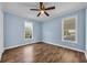 Bedroom showcasing wood laminate flooring, ceiling fan, two windows and blue wall paint at 5589 Highway 668, Conway, SC 29526