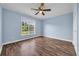 This bedroom has blue walls, a ceiling fan and hardwood floor at 5589 Highway 668, Conway, SC 29526