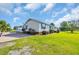 Exterior view featuring a well-maintained yard, screened in porch, and charming blue shutters at 5589 Highway 668, Conway, SC 29526