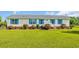 Charming single story home featuring bright blue shutters, a manicured lawn, and an inviting front porch at 5589 Highway 668, Conway, SC 29526