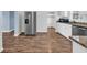 Modern kitchen featuring stainless steel appliances, granite countertops, and stylish wood look flooring at 5589 Highway 668, Conway, SC 29526