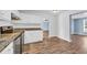 Modern kitchen features stainless steel appliances, white cabinets, and hardwood floors at 5589 Highway 668, Conway, SC 29526