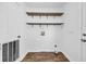 Functional laundry room featuring laminate flooring, open shelving and utility closet at 5589 Highway 668, Conway, SC 29526