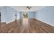 Bright living room with wood floors, blue walls, ceiling fan, and sliding glass door to outside deck at 5589 Highway 668, Conway, SC 29526
