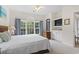 Bright bedroom featuring a large window with natural light, a TV, and comfortable furnishings at 5750 Oyster Catcher Dr. # 822, North Myrtle Beach, SC 29582