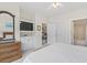 Bedroom with dresser, mounted TV, a view to the dining area and ensuite bathroom at 5750 Oyster Catcher Dr. # 822, North Myrtle Beach, SC 29582