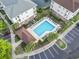 Aerial view of community pool showcasing its layout, surrounding greenery and nearby parking at 5750 Oyster Catcher Dr. # 822, North Myrtle Beach, SC 29582