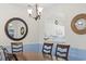 Cozy dining area featuring a wooden table and chairs, chandelier, and view into the kitchen at 5750 Oyster Catcher Dr. # 822, North Myrtle Beach, SC 29582