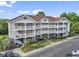 Spacious multi-level condo complex featuring charming balconies, manicured landscaping, and ample parking at 5750 Oyster Catcher Dr. # 822, North Myrtle Beach, SC 29582