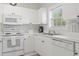 Clean kitchen with white cabinets, modern appliances, and abundant natural light from the window at 5750 Oyster Catcher Dr. # 822, North Myrtle Beach, SC 29582