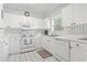 Inviting kitchen with white cabinets, appliances, and a window that brings in plenty of natural light at 5750 Oyster Catcher Dr. # 822, North Myrtle Beach, SC 29582