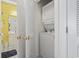 A laundry closet showing stacked washer and dryer with view to the vanity at 5750 Oyster Catcher Dr. # 822, North Myrtle Beach, SC 29582