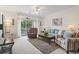 Bright living room with comfortable seating, a ceiling fan, and access to outdoor balcony at 5750 Oyster Catcher Dr. # 822, North Myrtle Beach, SC 29582