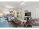 Living area with sofa, dining table, accent chair, open floor plan and natural light at 5750 Oyster Catcher Dr. # 822, North Myrtle Beach, SC 29582