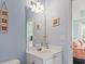 Bright bathroom featuring a vanity, mirror, lighting and adjacent bedroom at 5801 Oyster Catcher Dr. # 332, North Myrtle Beach, SC 29582