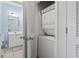 The bathroom leads to a laundry closet with a stacked washer and dryer at 5801 Oyster Catcher Dr. # 332, North Myrtle Beach, SC 29582