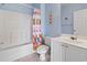 Bright bathroom with tub/shower combination, white vanity, and colorful shower curtain at 5801 Oyster Catcher Dr. # 332, North Myrtle Beach, SC 29582