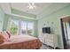 Light and airy bedroom boasts natural light, dresser and ceiling fan at 5801 Oyster Catcher Dr. # 332, North Myrtle Beach, SC 29582