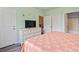Comfortable bedroom features a dresser, large TV, and a view into the en-suite bathroom at 5801 Oyster Catcher Dr. # 332, North Myrtle Beach, SC 29582
