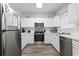 Well-lit kitchen with white cabinetry, stainless steel appliances, and wood-look flooring at 5801 Oyster Catcher Dr. # 332, North Myrtle Beach, SC 29582